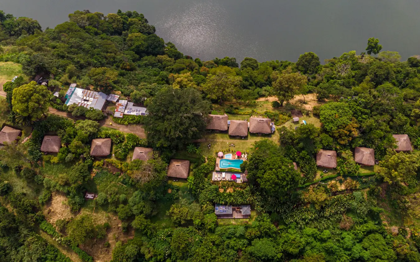 Aerial view of safari lodge nestled among trees and vegetation, Ndali Lodge, Kibale Forest, Uganda