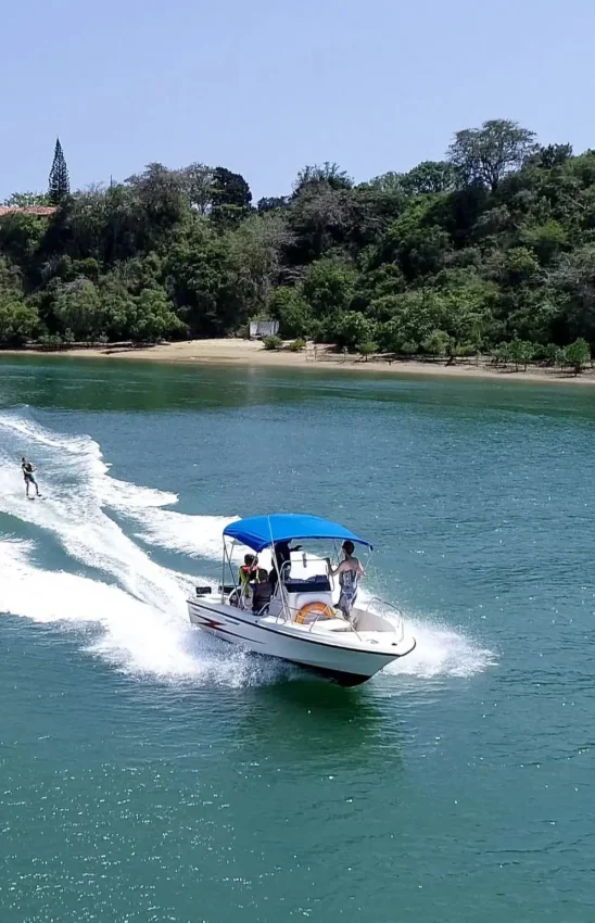 Speedboat with passengers navigating waves near tropical beach cove, Nderit House, Kilifi, Kenya