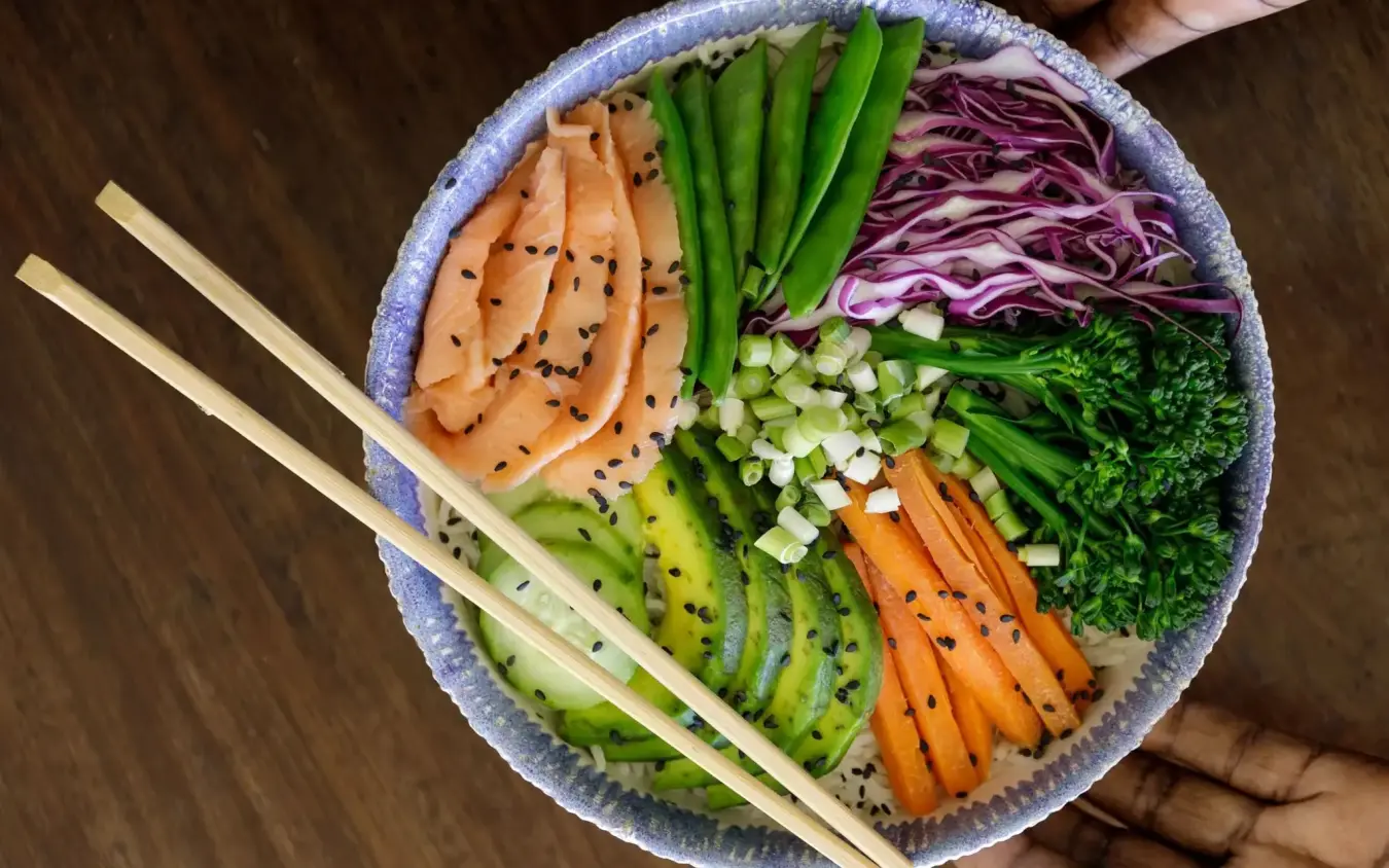 Overhead view of sushi bowl with salmon, avocado and fresh vegetables, Nderit House, Kilifi, Kenya