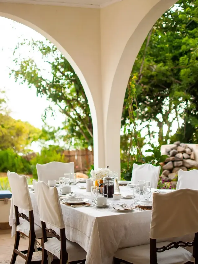 Outdoor dining table set for breakfast with garden views, Nderit House, Kilifi, Kenya