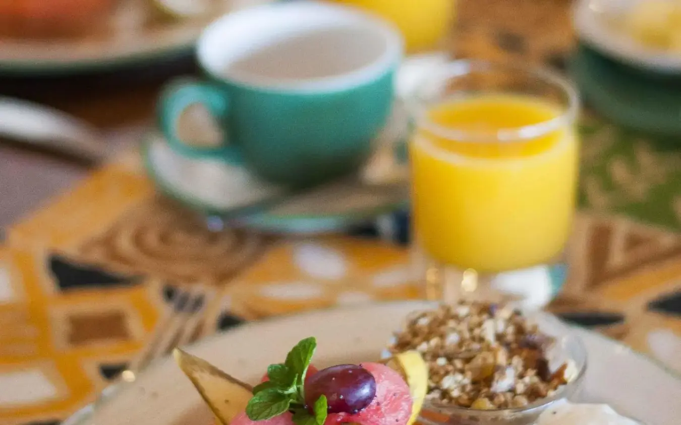 Breakfast plate with fruit, eggs, and almonds on table, Ndutu Safari Lodge, Serengeti National Park, Tanzania