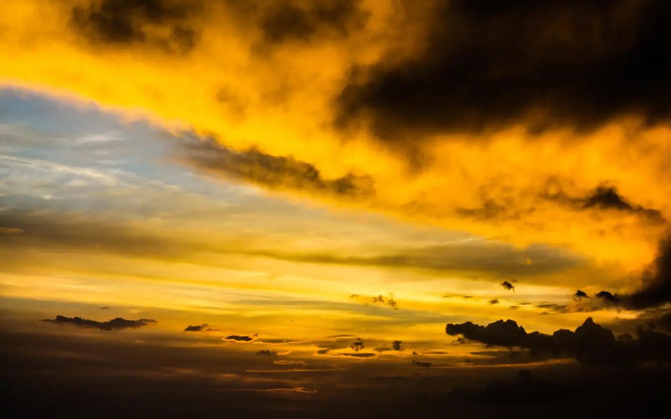 Golden sunset sky with dramatic storm clouds and silhouettes, Ndutu Safari Lodge, Serengeti National Park, Tanzania