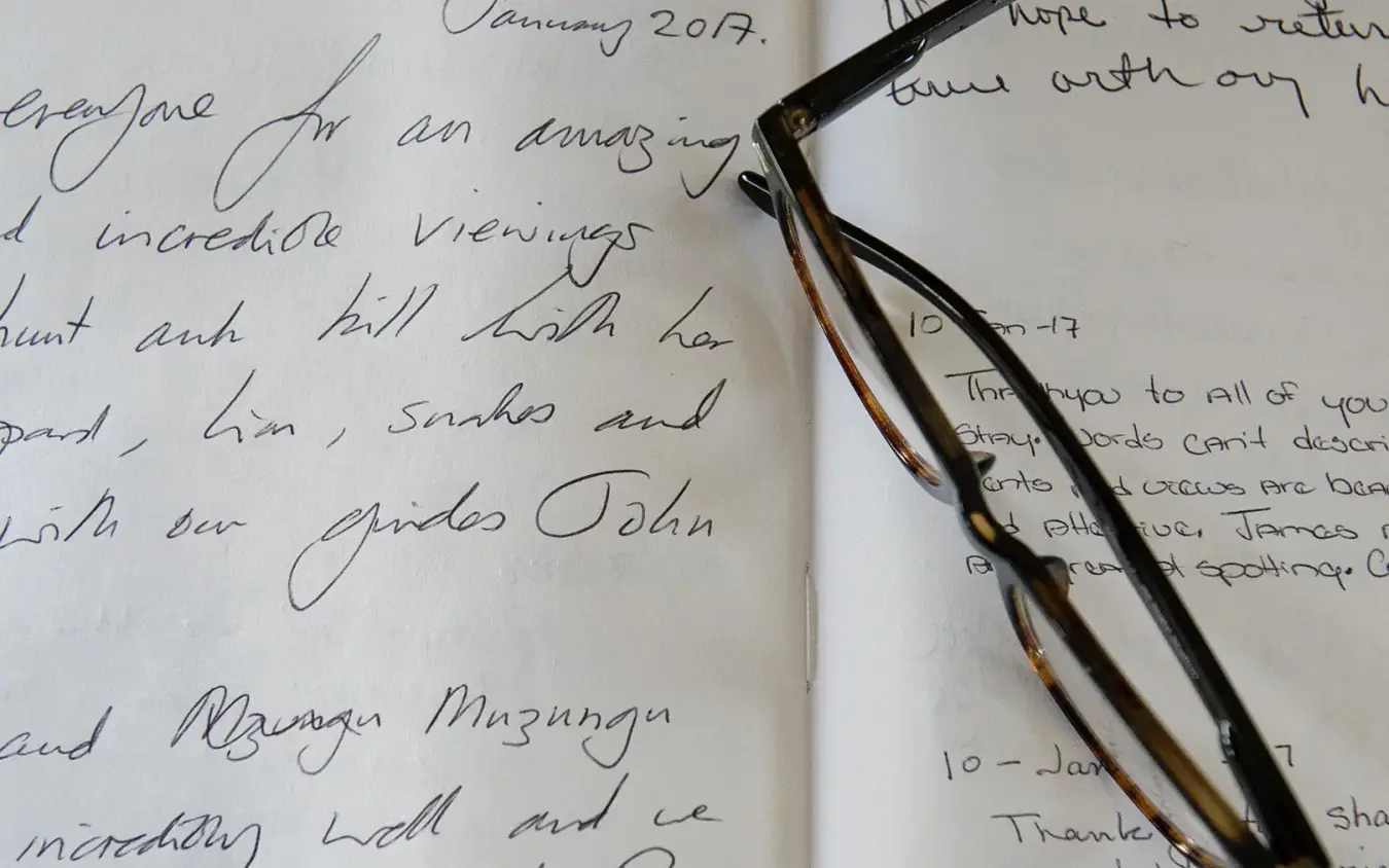 Handwritten letters and vintage eyeglasses on paper, Ngare Serian, Maasai Mara, Kenya