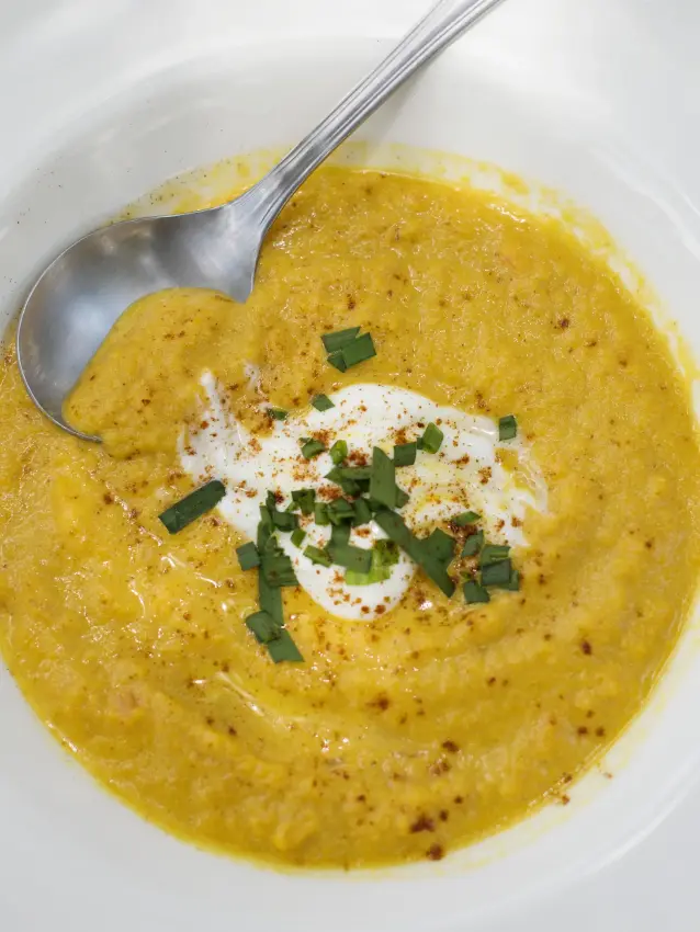 Golden curry soup with cream and chive garnish, Ngare Serian, Maasai Mara, Kenya