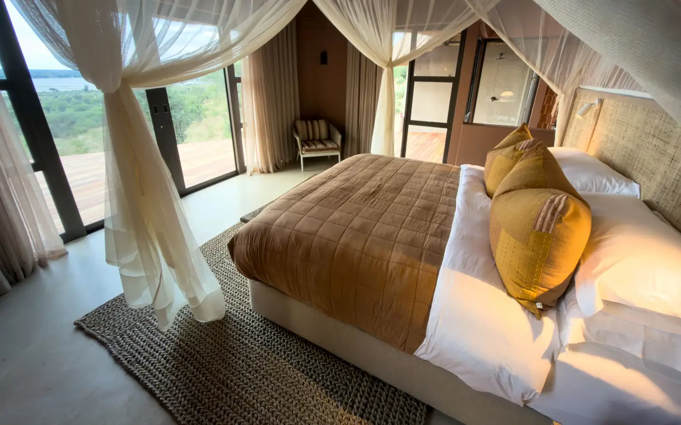 Luxury bedroom with canopy bed and valley views from private terrace, Ngoma Safari Lodge, Chobe, Botswana