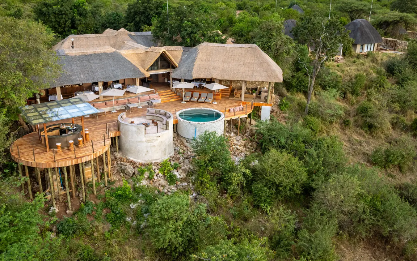 Luxury treehouse lodge with thatched roofs and circular pool nestled in forest, Ngoma Safari Lodge, Chobe, Botswana