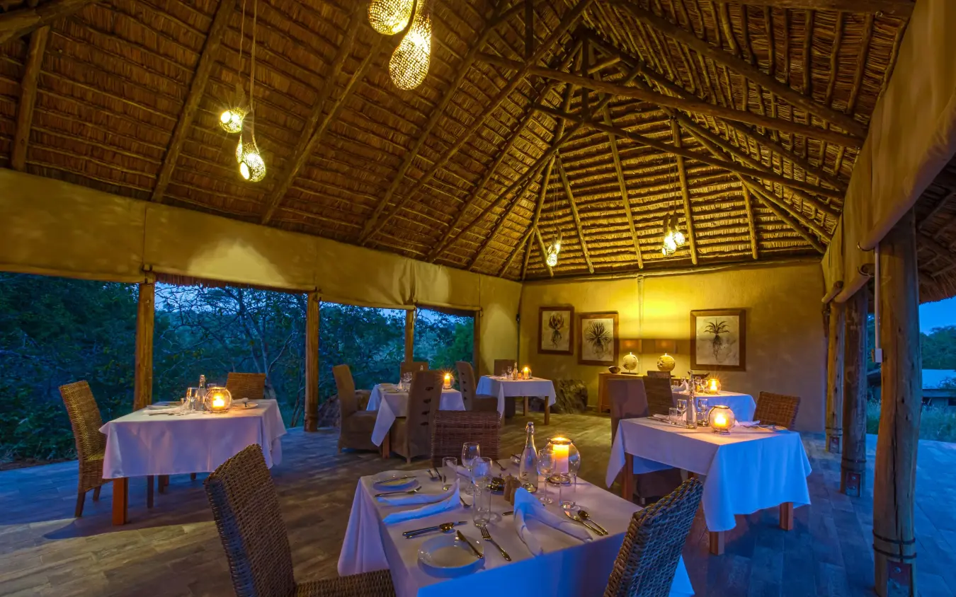 Evening dining pavilion with set tables and ambient lighting, Nimali Tarangire, Tarangire National Park, Tanzania