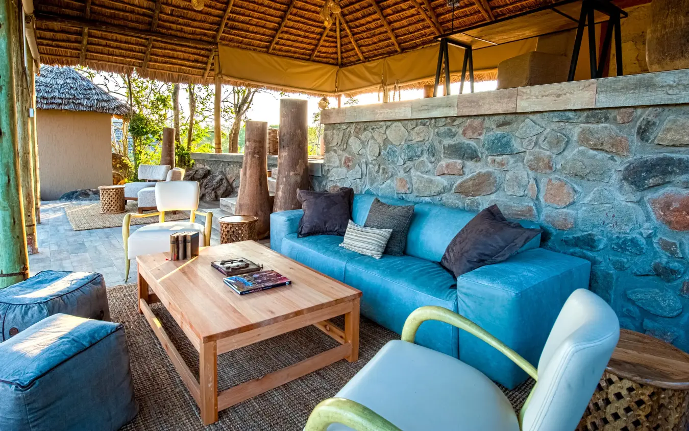 Open-air lounge with blue seating and stone walls, Nimali Tarangire, Tarangire National Park, Tanzania