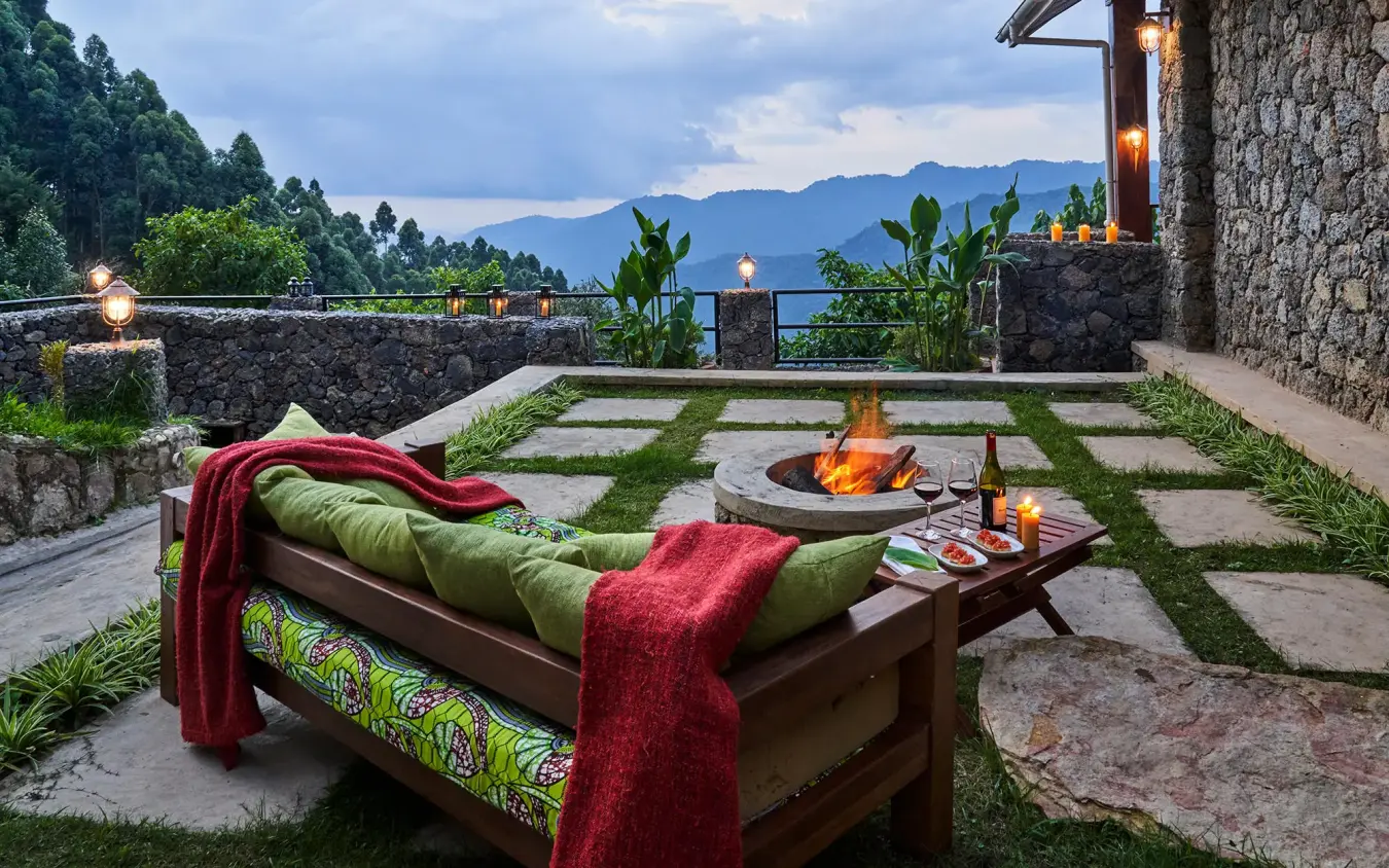 Mountain vista from stone terrace with firepit seating, Nkuringo Gorilla Lodge, Bwindi Impenetrable Forest, Uganda