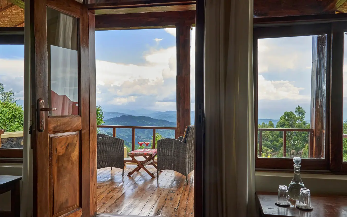 Wooden deck with chairs overlooking distant mountains and lake, Nkuringo Gorilla Lodge, Bwindi Impenetrable Forest, Uganda