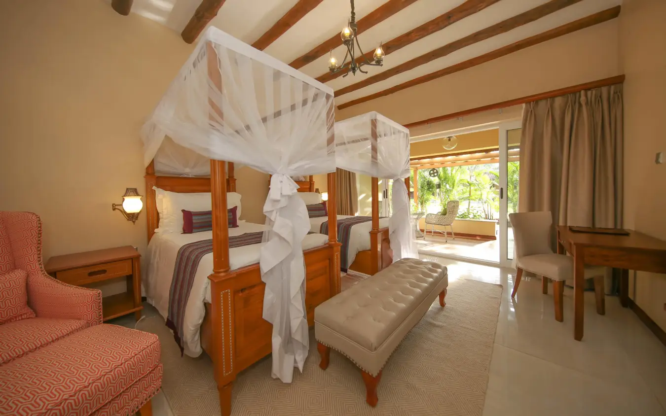 Spacious bedroom with wooden four-poster canopy beds, No.5 Boutique Hotel, Entebbe and Kampala, Uganda