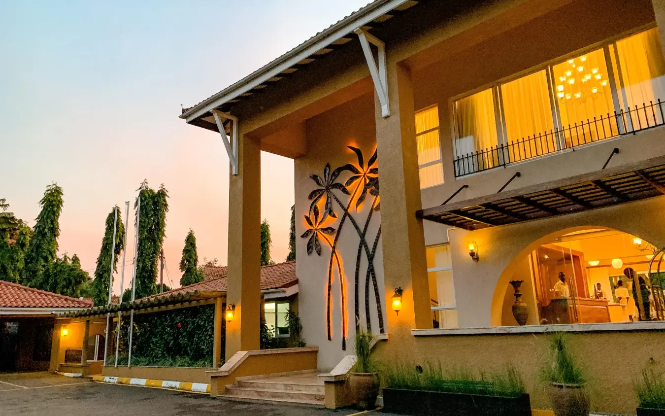 Modern lodge building with tall windows at dusk, No.5 Boutique Hotel, Entebbe and Kampala, Uganda