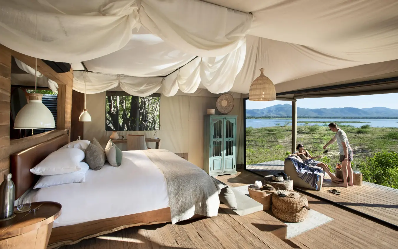 Bedroom interior with draped ceiling overlooking savanna landscape, Nyamatusi Camp, Mana Pools, Zimbabwe