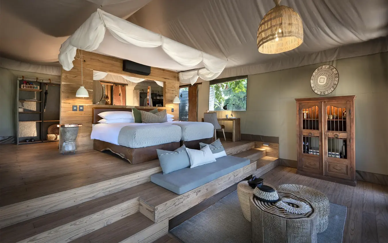 Spacious safari tent bedroom with wooden furnishings and lounge area, Nyamatusi Camp, Mana Pools, Zimbabwe