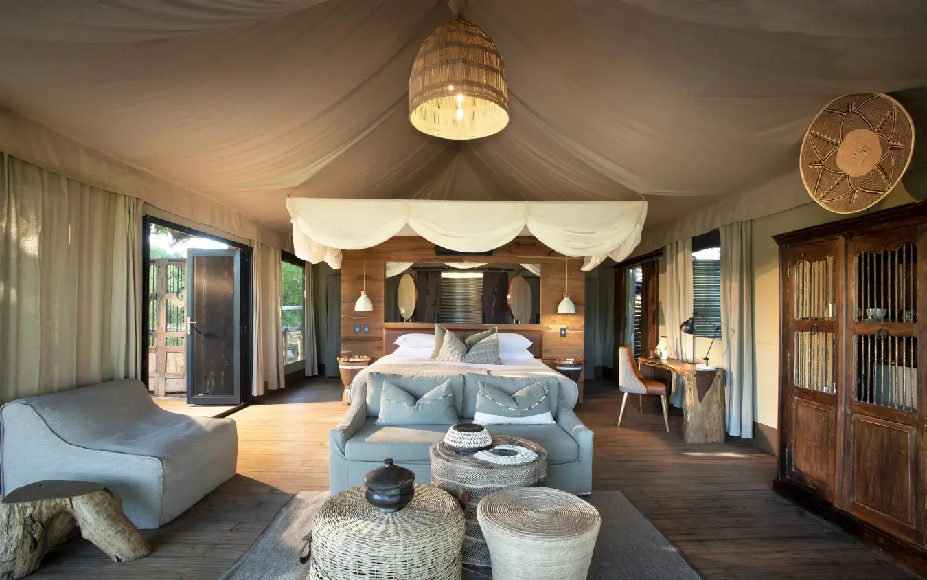 Spacious safari tent bedroom with wooden furnishings and seating, Nyamatusi Camp, Mana Pools, Zimbabwe