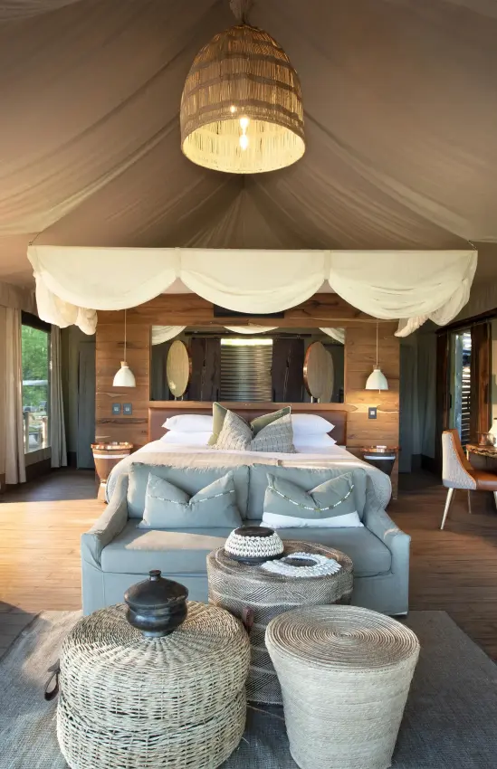 Spacious safari tent bedroom with wooden furnishings and seating, Nyamatusi Camp, Mana Pools, Zimbabwe