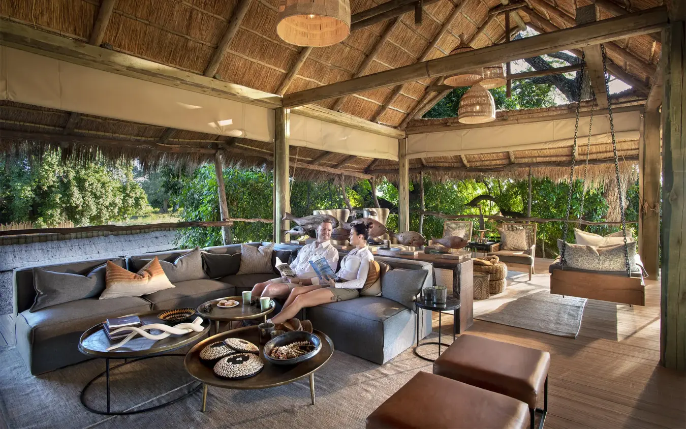 Covered lounge area with seating and thatched roof structure, Nyamatusi Camp, Mana Pools, Zimbabwe