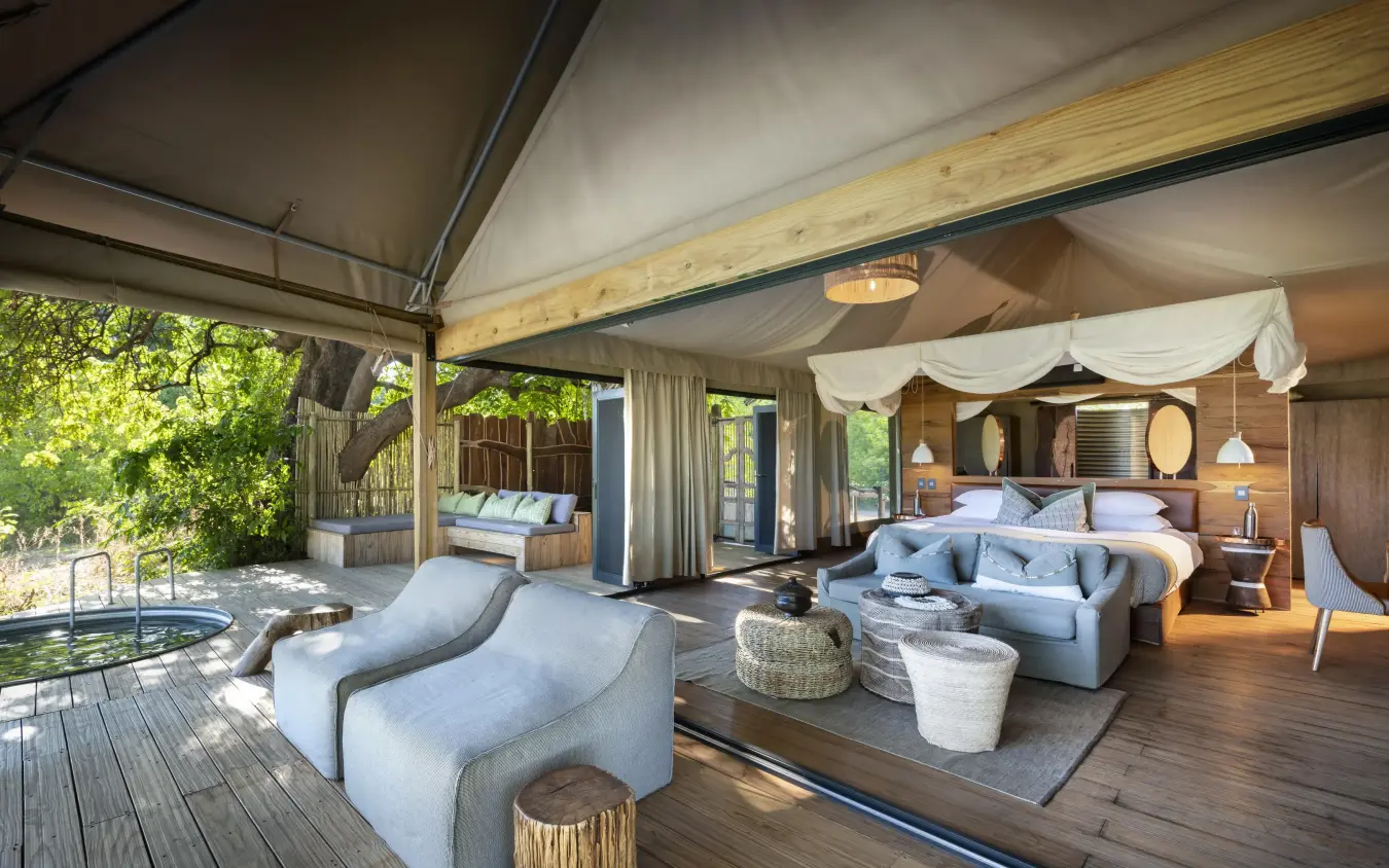 Open-air lounge with seating and bedroom visible beyond, Nyamatusi Camp, Mana Pools, Zimbabwe