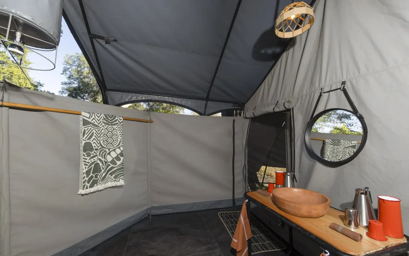 Outdoor safari camp bathroom with wooden basin sink, Kweene Trails, The Okavango Delta, Botswana