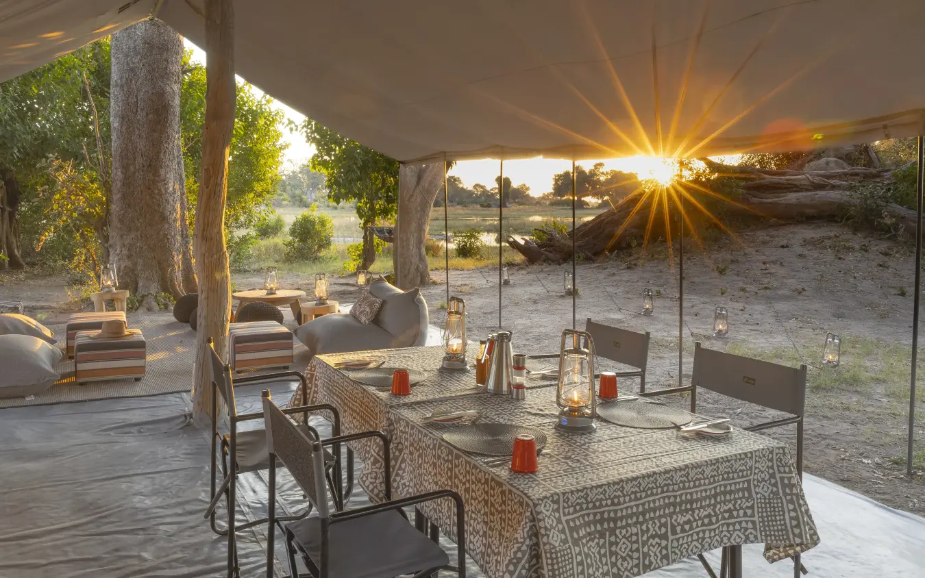 Open-air dining pavilion with sunset view over savanna, Kweene Trails, The Okavango Delta, Botswana