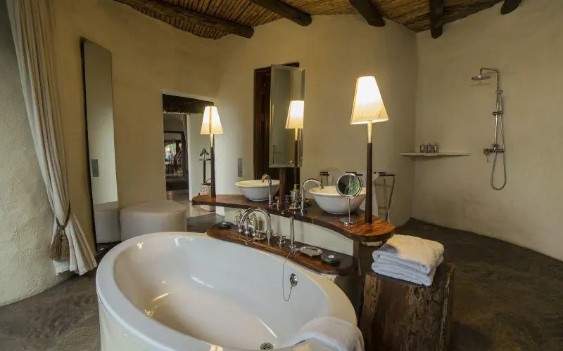 Luxury bathroom with freestanding tub and dual vanity, Ol Donyo Lodge, Amboseli and Chyulu Hills, Kenya