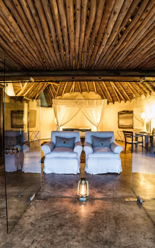 Luxury safari tent bedroom with twin beds and canvas furnishings, Ol Donyo Lodge, Amboseli and Chyulu Hills, Kenya