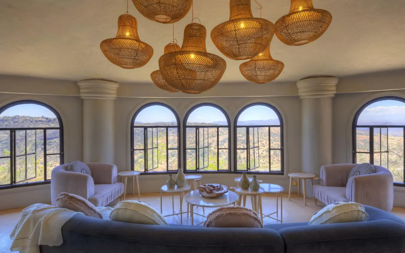 Modern lounge with woven pendant lights and panoramic windows, Ol Lentille, Laikipia Highlands, Kenya