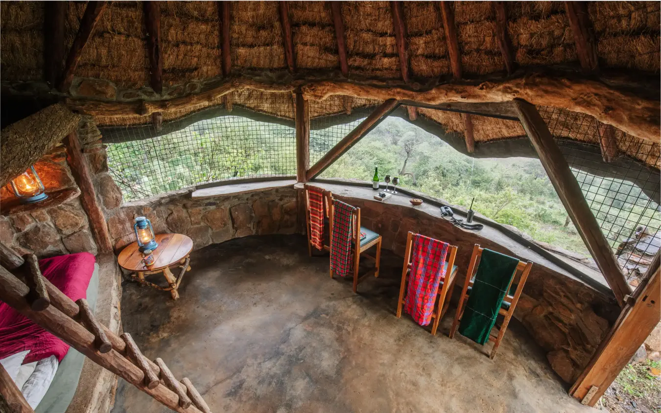 Interior of rustic lodge with panoramic wildlife viewing windows, Ol Malo Lodge, Laikipia Highlands, Kenya