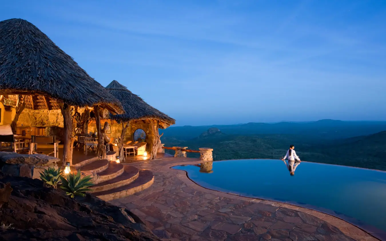 Infinity pool overlooking savanna landscape at dusk, Ol Malo Lodge, Laikipia Highlands, Kenya