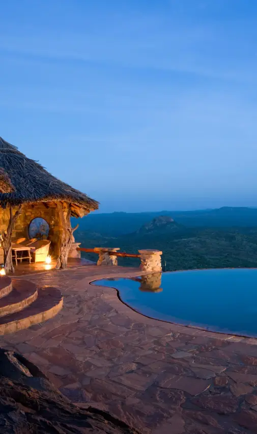 Infinity pool overlooking savanna landscape at dusk, Ol Malo Lodge, Laikipia Highlands, Kenya