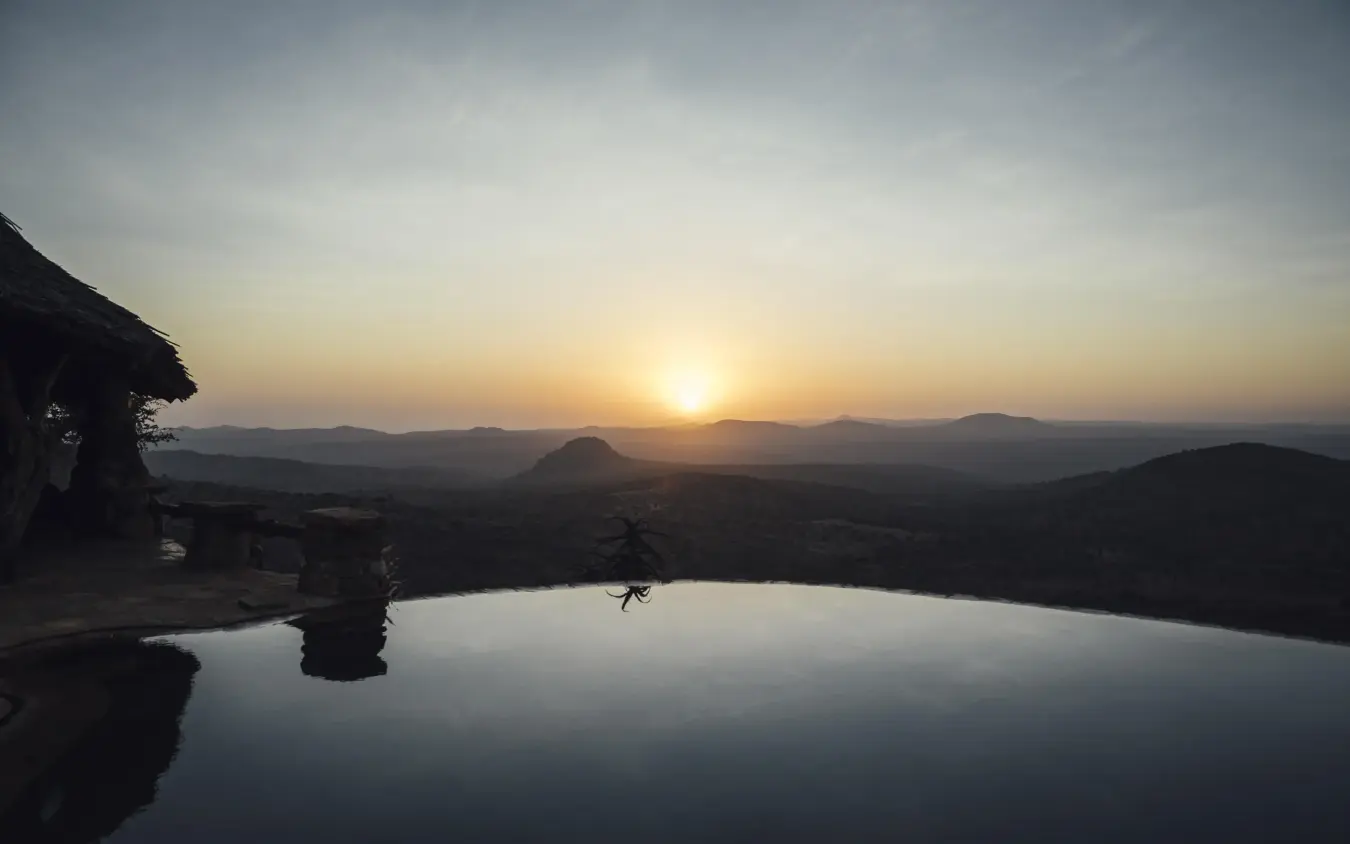 Infinity pool at sunset overlooking distant mountains, Ol Malo Lodge, Laikipia Highlands, Kenya