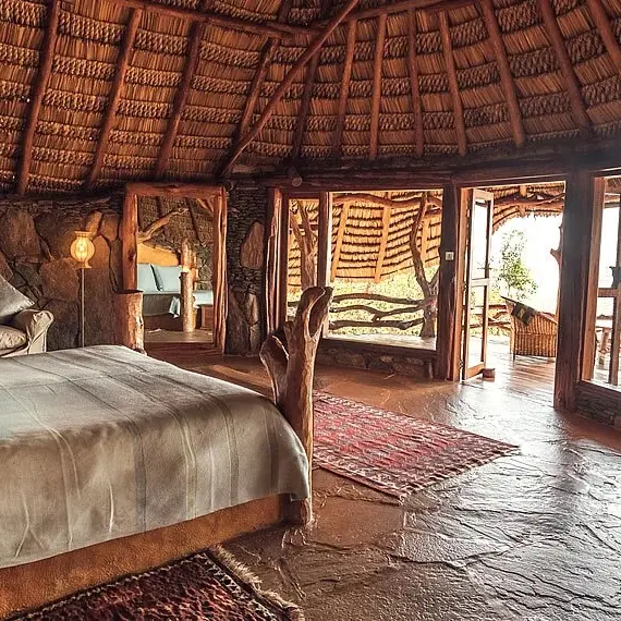 Spacious bedroom with thatch roof and panoramic windows, Ol Malo Lodge, Laikipia Highlands, Kenya