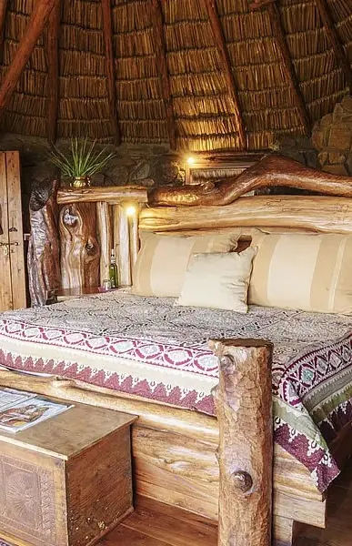 Rustic wooden bedroom interior with thatched roof dome, Ol Malo Lodge, Laikipia Highlands, Kenya