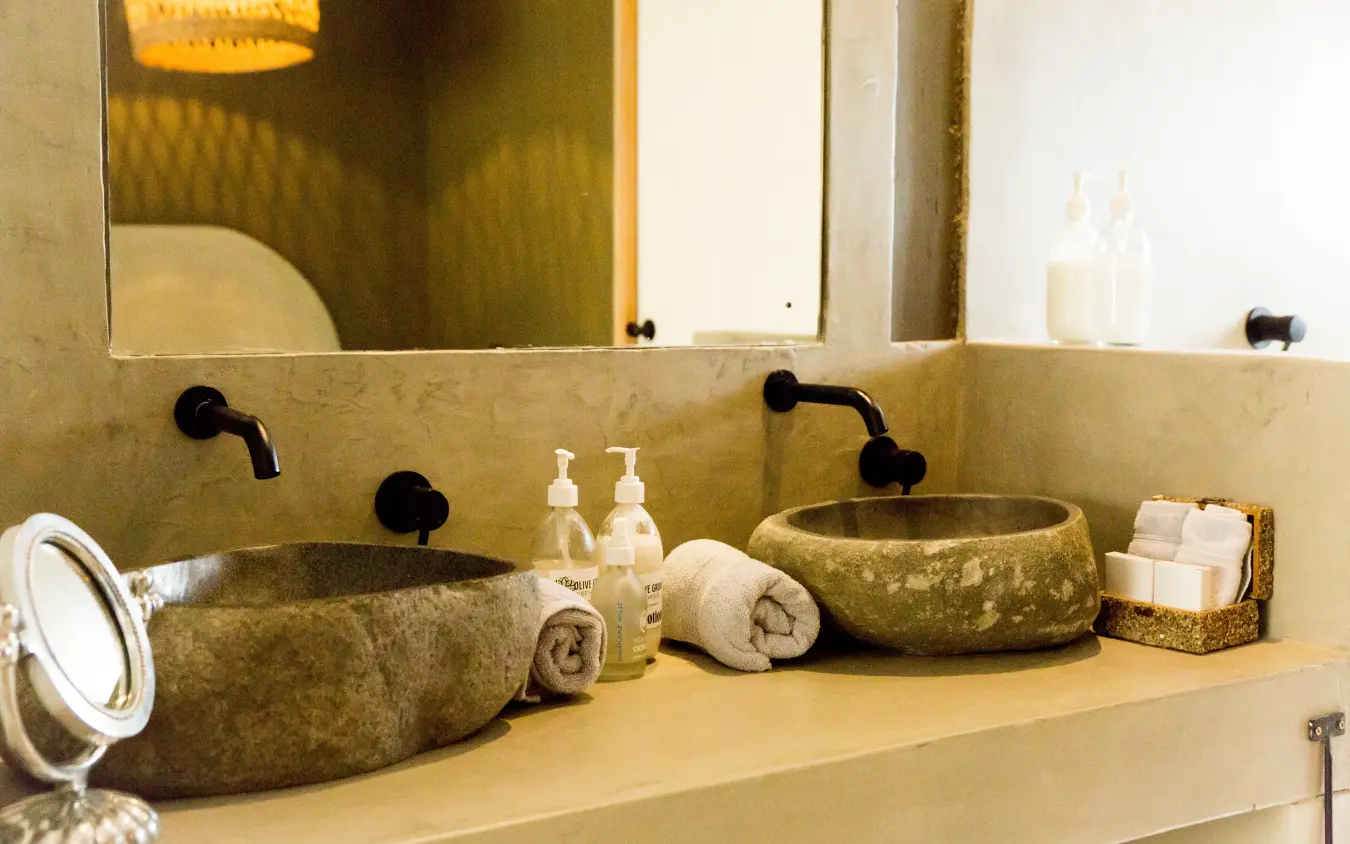 Luxury bathroom vanity with dual stone basins and black fixtures, Olive Grove Guesthouse, Windhoek, Namibia