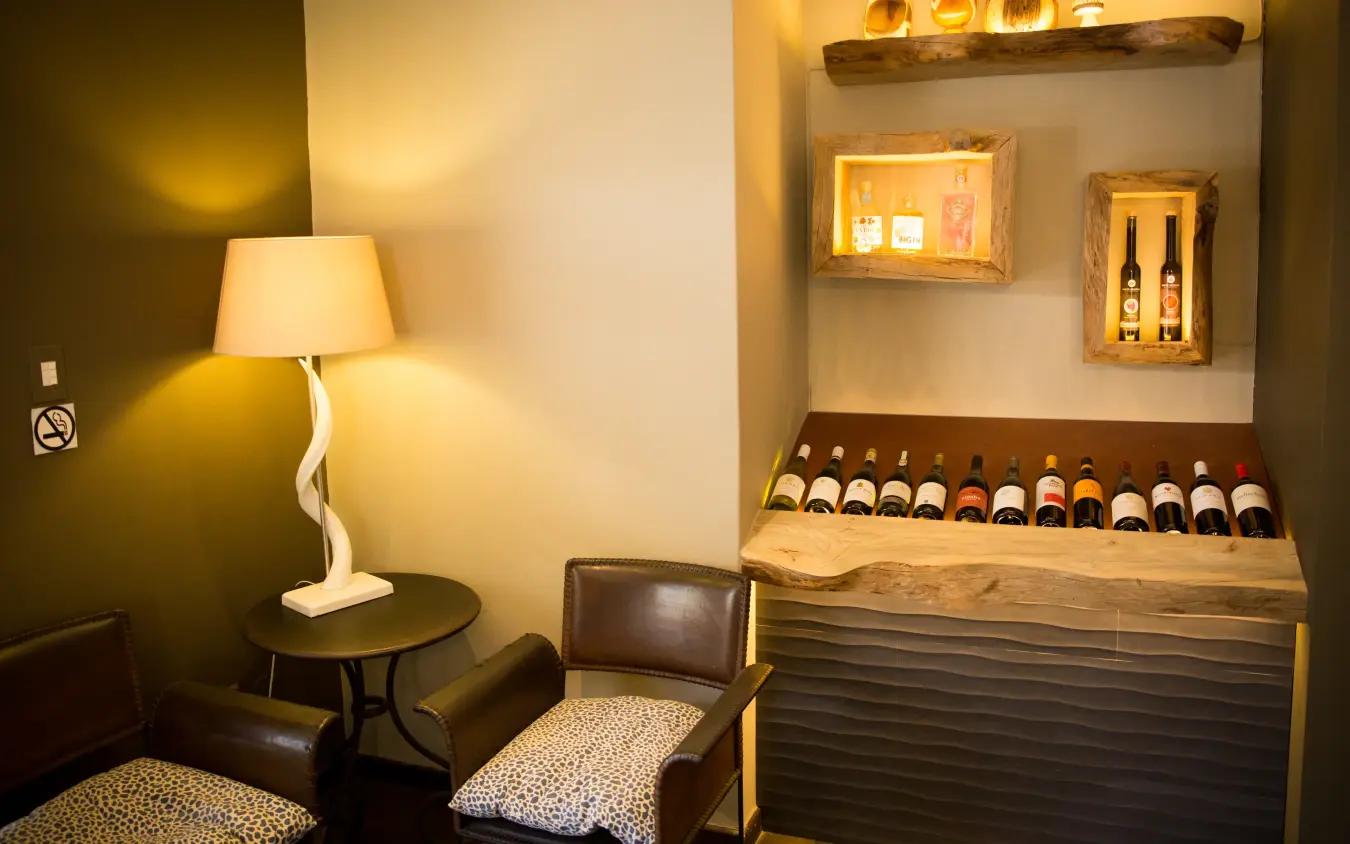 Wine tasting room with leather seating and illuminated display shelves, Olive Grove Guesthouse, Windhoek, Namibia
