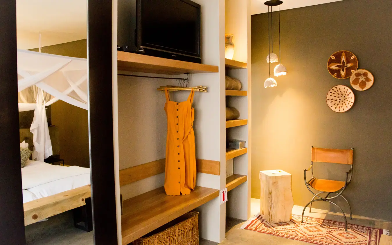 Modern safari lodge bedroom with wooden furnishings and warm ambient lighting, Olive Grove Guesthouse, Windhoek, Namibia
