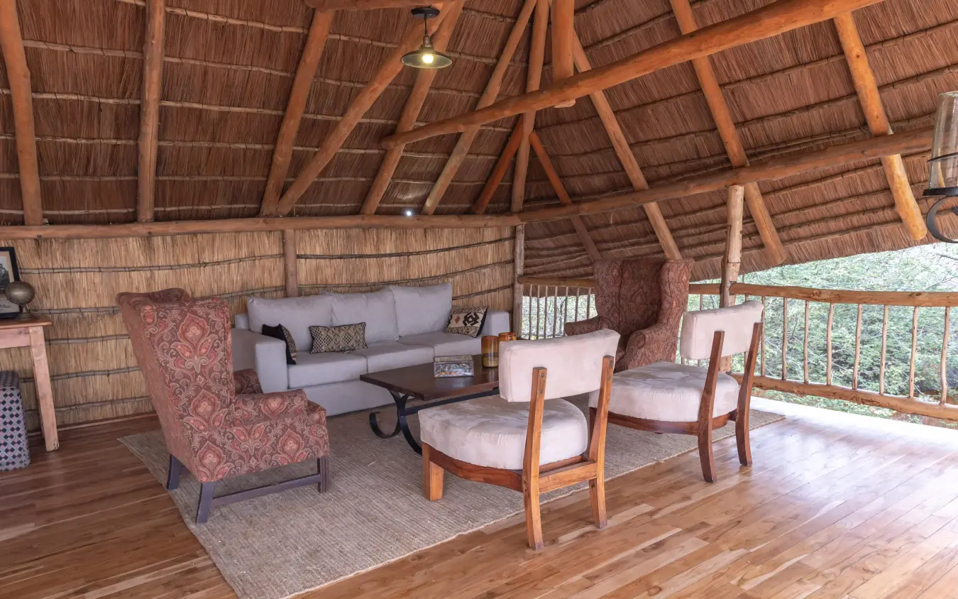 Thatched roof lounge with wooden beams and seating area, Oliver’s Camp, Tarangire National Park, Tanzania