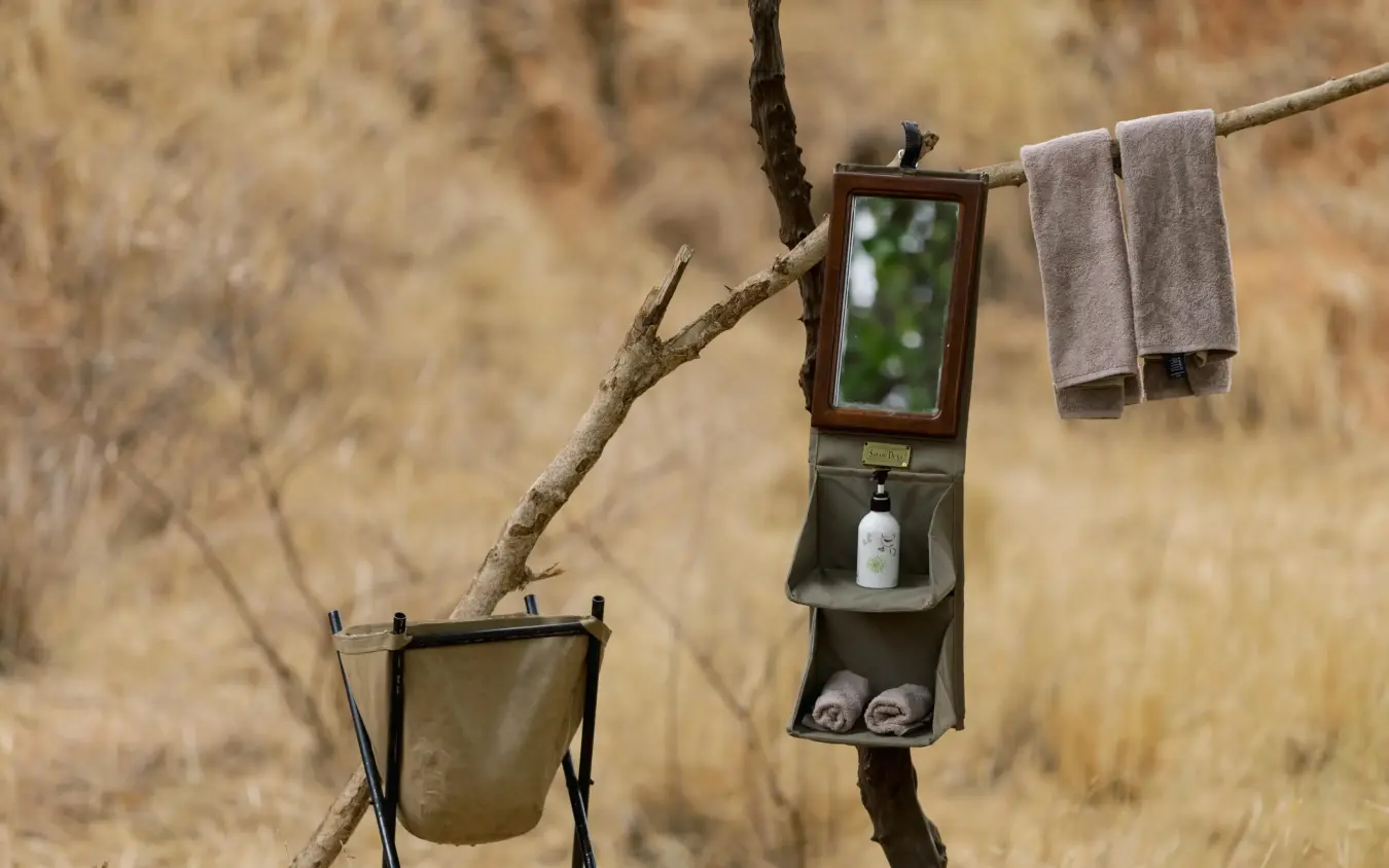 Portable safari bathroom station hanging from tree branch in wilderness camp, Olkeri Camp, Tarangire National Park, Tanzania
