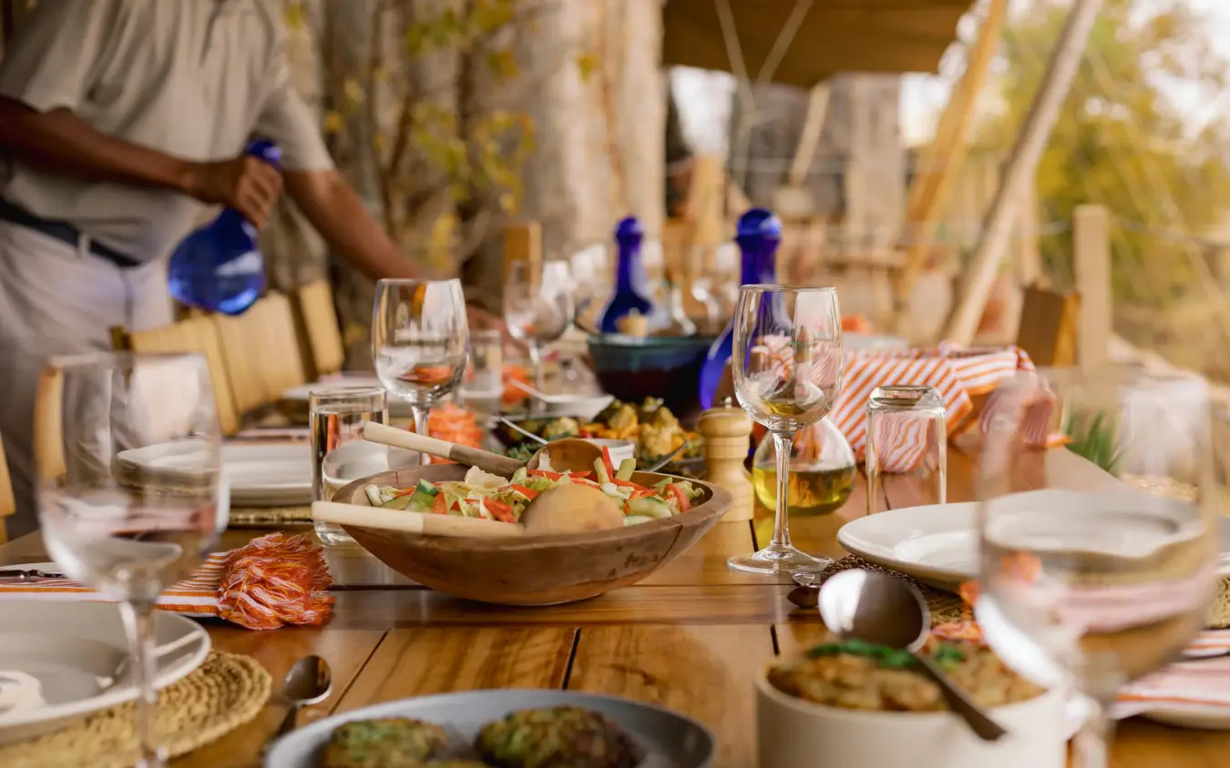 Outdoor dining table set with food and beverages under canvas canopy, Olkeri Camp, Tarangire National Park, Tanzania