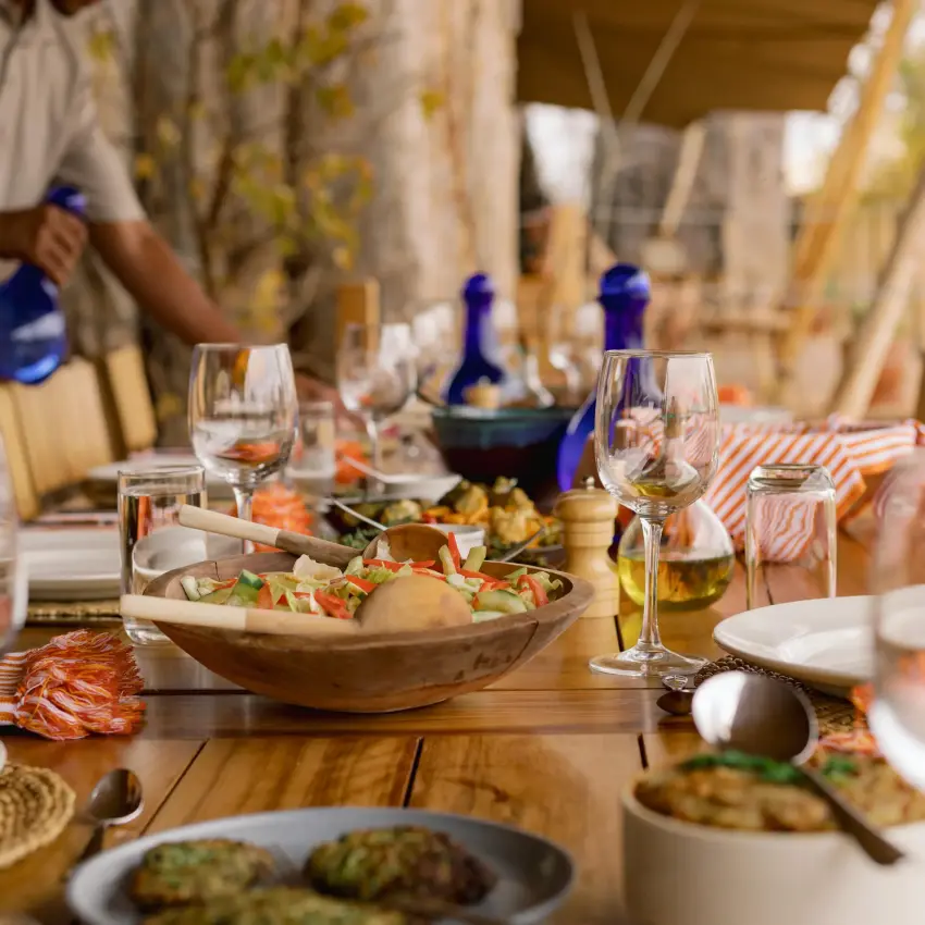 Outdoor dining table set with food and beverages under canvas canopy, Olkeri Camp, Tarangire National Park, Tanzania