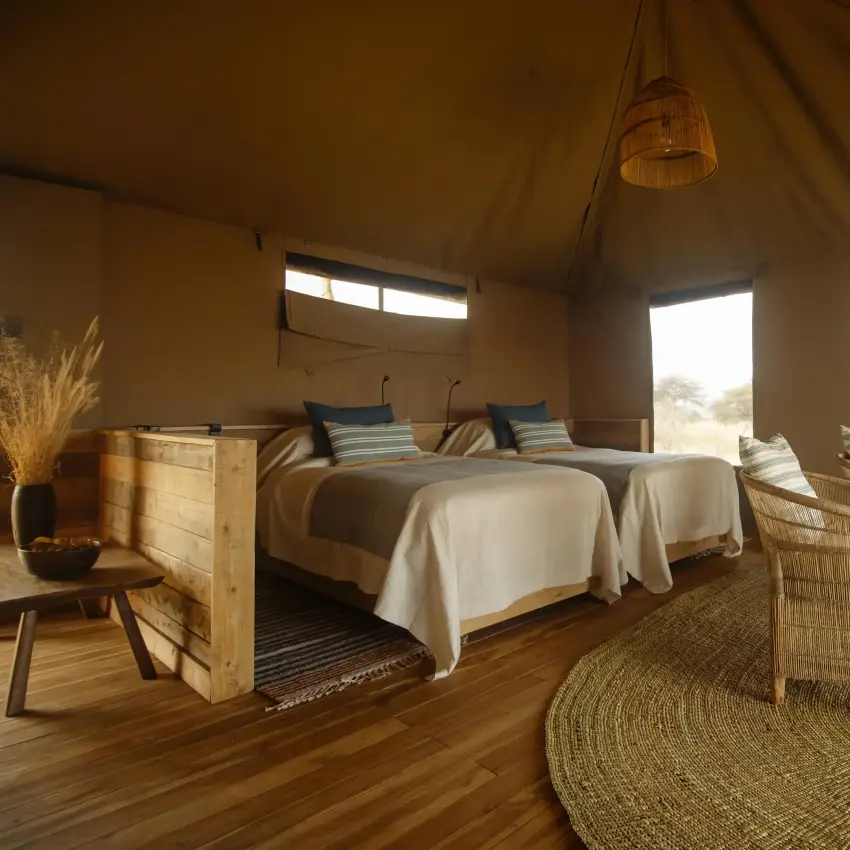 Luxury safari tent interior with twin beds and landscape views, Olkeri Camp, Tarangire National Park, Tanzania