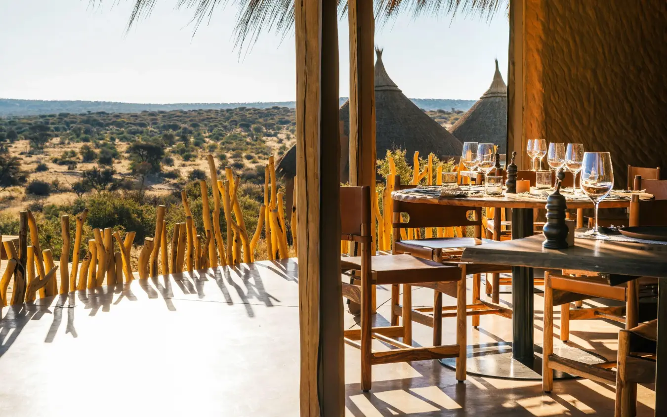 Dining terrace overlooking savanna landscape with acacia trees, Omaanda, Windhoek, Namibia