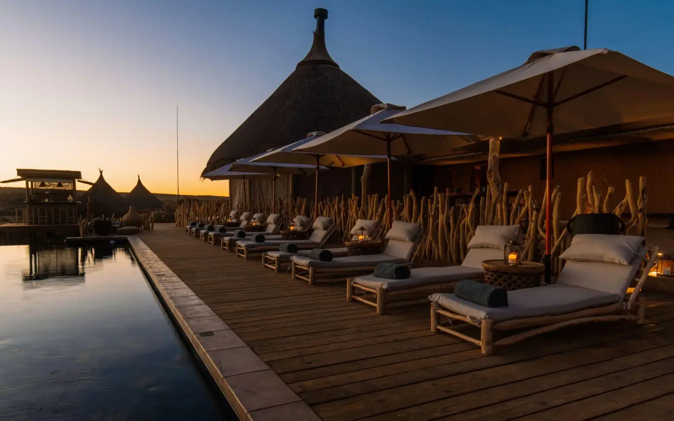 Waterfront wooden deck with loungers at sunset, Omaanda, Windhoek, Namibia