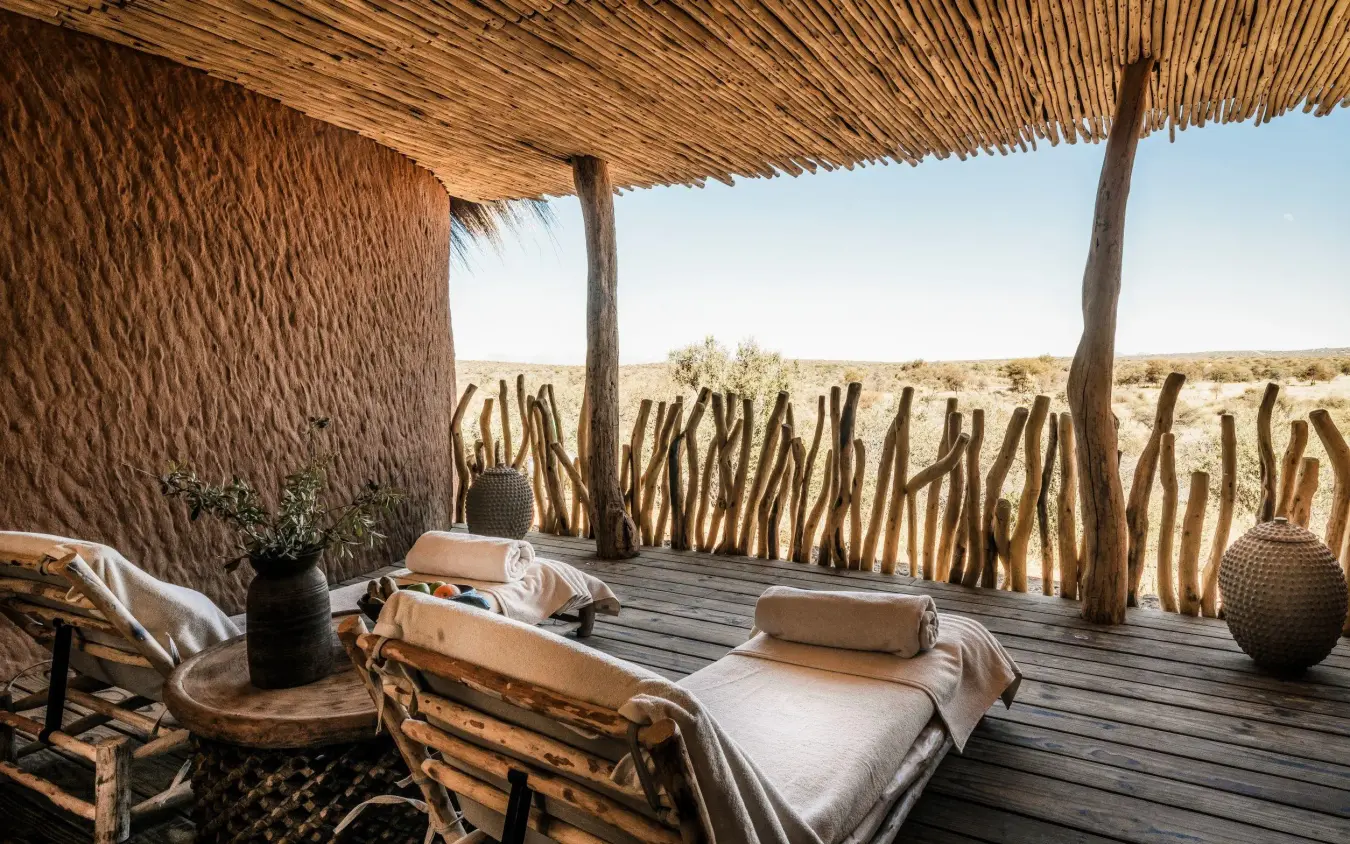 Desert lodge deck with wooden furniture and cacti views, Omaanda, Windhoek, Namibia