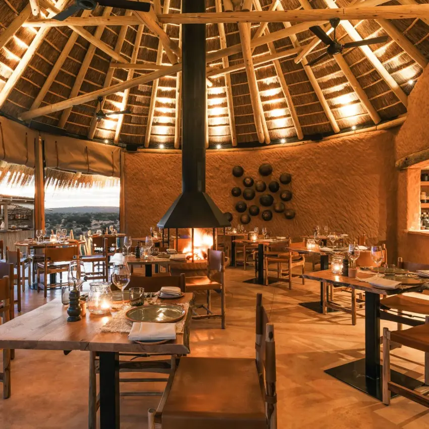 Circular dining room with central fireplace and thatched roof, Windhoek, Namibia