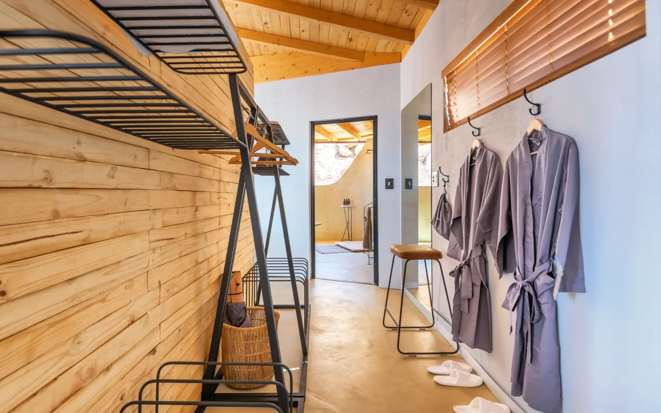 Interior spa or wellness area with wooden beams and robes, Onduli Ridge, Damaraland, Namibia