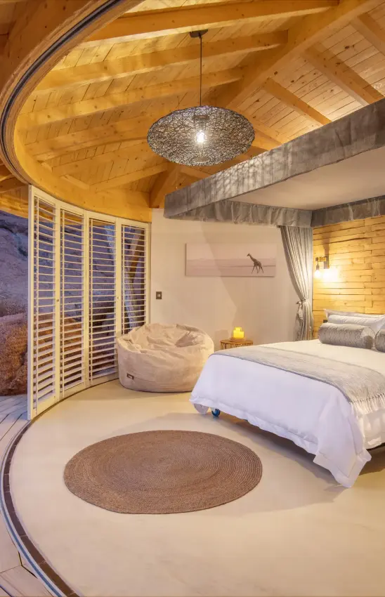 Luxury bedroom with canopy bed and desert rock views, Onduli Ridge, Damaraland, Namibia