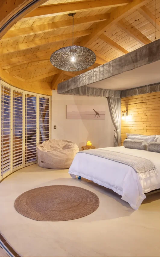 Luxury bedroom with canopy bed and desert rock views, Onduli Ridge, Damaraland, Namibia