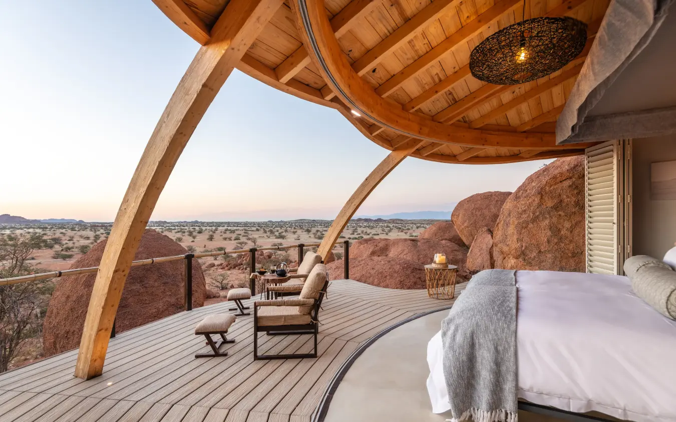 Bedroom deck with boulder formations and savanna views, Onduli Ridge, Damaraland, Namibia