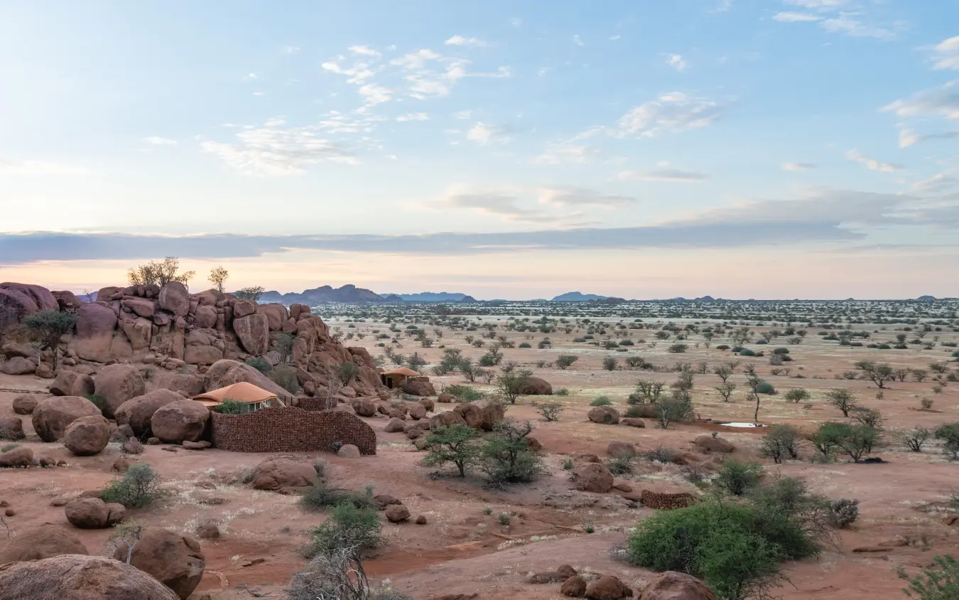Rocky outcrops overlooking savanna plains at sunset, Onduli Ridge, Damaraland, Namibia